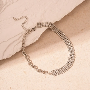 Modern half rhinestone and half silver chain link necklace on a natural stone base