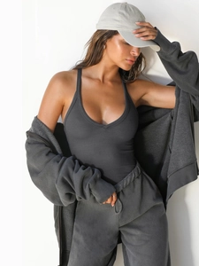 Detailed texture of dark grey ribbed bodysuit and matching zip-up hoodie set