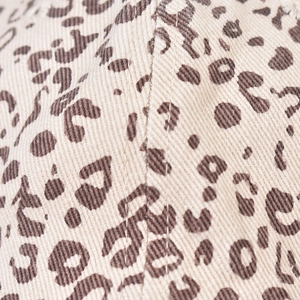 Dettaglio del cappellino leopardato che mostra la trama del tessuto e le cuciture