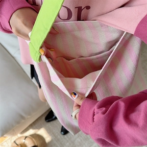 Detail of the pink striped canvas tote bag showing inner slip pocket and large capacity