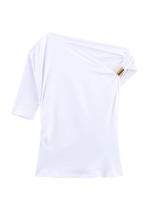 Close-up of asymmetrical white T-shirt featuring a decorative gold metal shoulder buckle