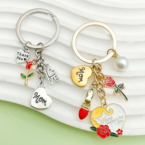Detail view of gold and silver Mother's Day keychains with floral charms and love pendants