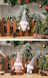 Macro detail of plush grey and pink Christmas gnomes with knit hats and faux fur beards