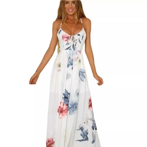 Detail of the white floral maxi dress featuring a V-neckline and adjustable spaghetti straps