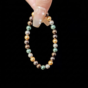 Bracelet élastique élégant en perles multicolores dorées, argentées et vertes