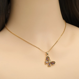 Gold plated butterfly necklace with purple gems pendant on model neck profile