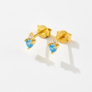 Macro shot of S925 sterling silver studs with sky blue stones and butterfly clasp