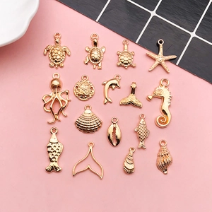 Detailed view of fifteen gold sea animal charms including turtle starfish and dolphin