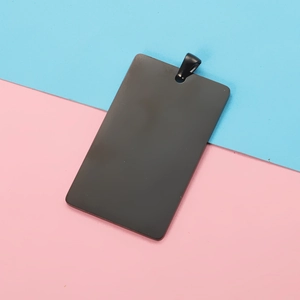 Polished black rectangular stainless steel pet tag pendant with hanging ring on a dual-tone background