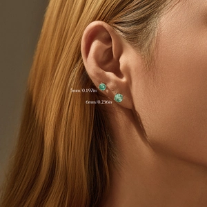 S925 silver stud earrings with 5mm and 6mm green gemstones on model's ear
