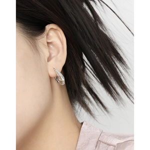 Modern S925 sterling silver geometric hollow earrings shown on a female model