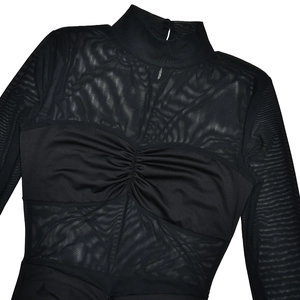 Detailed view of black mesh sheer fabric with ruched details and high neck design