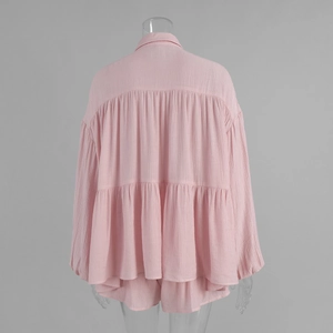 Detail showing the layered ruffle hem and textured fabric on the back of this pink shirt set