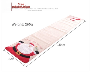 Detailed view of 180cm Christmas table runner with Santa Claus embroidery and Joy text