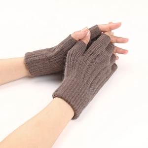 Close-up of brown cable knit fingerless gloves with ribbed texture on hands