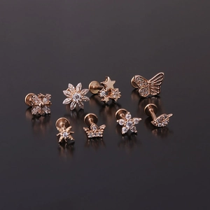 Rose gold 16G stainless steel labret stud set featuring zircon snowflake and butterfly designs