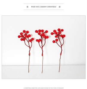 Detailed view of three artificial red berry stems for Christmas tree floral decoration