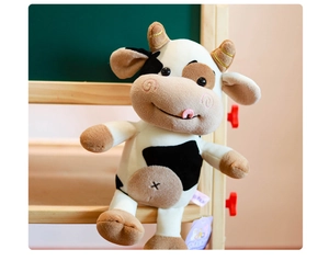 Adorable peluche de vaca con manchas negras y cuernos marrones para niños