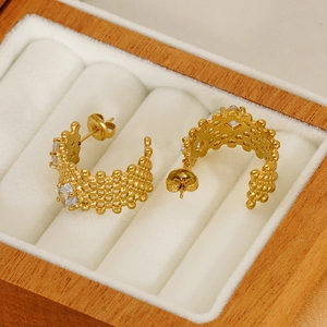 Golden C-shaped stainless steel earrings with beaded texture and zircon inlay in a box