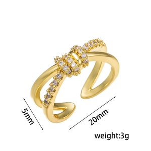 Minimalist double layer gold cross ring with cubic zirconia on white background