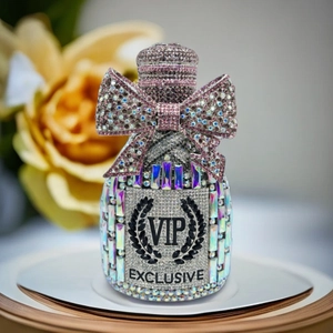 Macro detail of silver crystal bottle clutch with pink rhinestone bow and VIP engraving