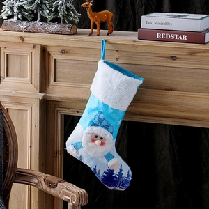 Blue LED Christmas stocking with 3D Santa Claus hanging on a cozy rustic fireplace