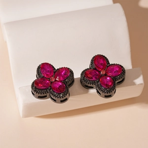 Macro shot of rose pink gemstone flower earrings with dark plated alloy setting