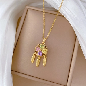 Detail of dreamcatcher necklace with colorful heart gems and feathers on jewelry box