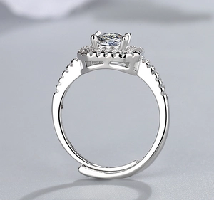 Detailed close-up of a silver halo ring with small side stones and adjustable band