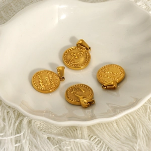 Golden vintage floral double-sided lucky flower charms on a white ceramic tray