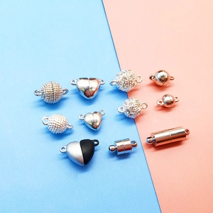 Detailed view of heart, sphere, and cylinder magnetic jewelry clasps in various metal finishes