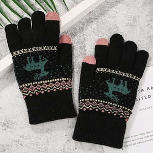 Detail of black knit winter gloves with pink touch-screen fingertips and reindeer pattern