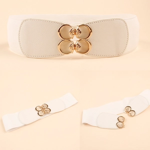 Detail of white elastic waist belt featuring a decorative gold four-ring floral buckle