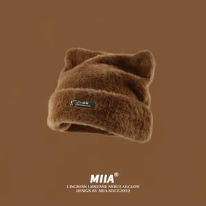 Brown faux mink fur knit hat featuring cute cat ears and a metallic logo tag