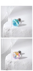 Detail of 8mm square crystal stud earrings in lake blue and iridescent yellow finish