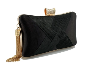 Detail of evening clutch featuring crystal-encrusted clasp and golden fringe tassels