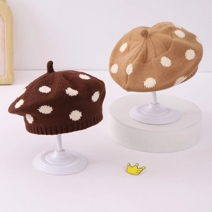 Detailed knit texture and polka dot pattern on brown and khaki berets for toddlers