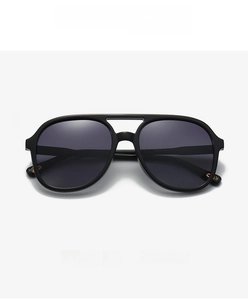 Front view of black double-bridge aviator sunglasses with gold metal temple accents