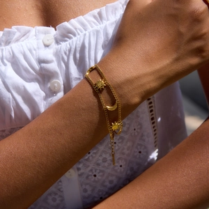 Classic 18K gold plated stainless steel sun and moon charm bracelet worn on wrist