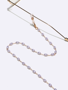 Close-up of lavender rice pearls and gold metal chain with silicone loops for glasses