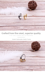 Detailed macro of gold and silver snake rings with textured scales on steel