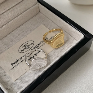 Detailed macro view of irregular molten metal S925 silver rings in gold and silver finish