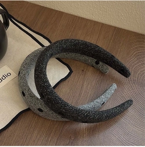 Detail view of thick grey and black velvet sponge headbands with knitted texture