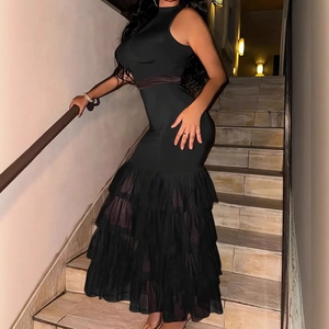 Detail of the multi-layered tiered tulle skirt on a sleeveless black knit maxi dress