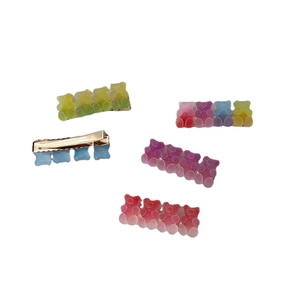 Five colorful resin gummy bear hair clips in candy colors shown on a white background