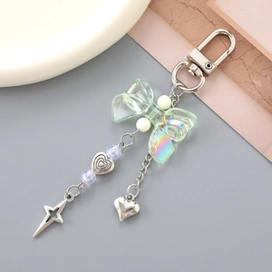 Sweet silver keychain with transparent green bow, metallic heart and star charms