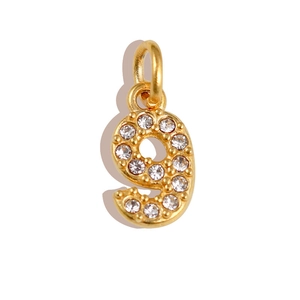 Detailed close-up of golden number 9 pendant with sparkling white cubic zirconia