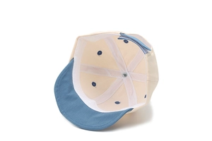 Détail du chapeau bébé en coton montrant les coutures et la sangle velcro réglable bleue