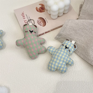 Detail view of plush bears with checkerboard pattern and metal bead chain for bags