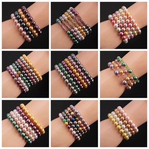 Grid view of 10mm shell pearl stretch bracelets in multiple colors on a model's wrist